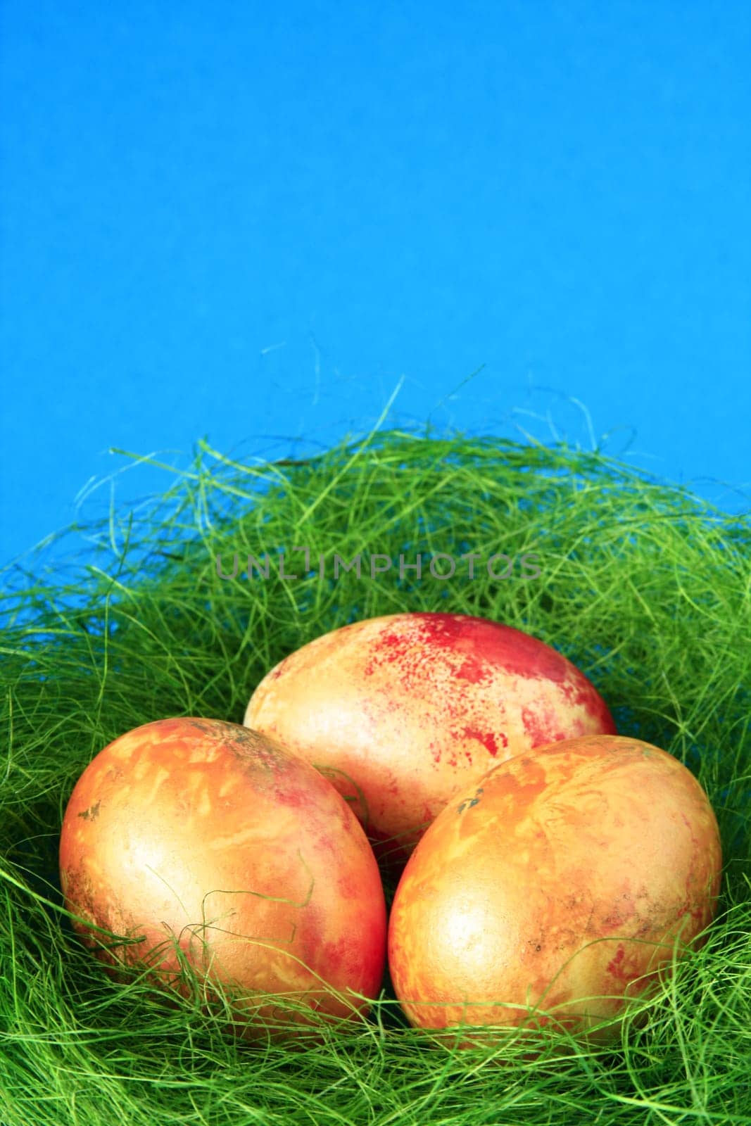 three easter eggs in green nest