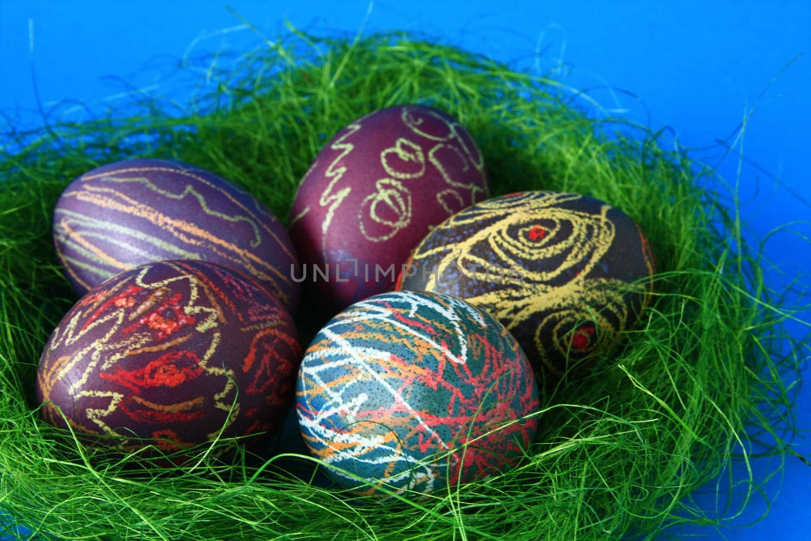 five brightly painted Easter eggs