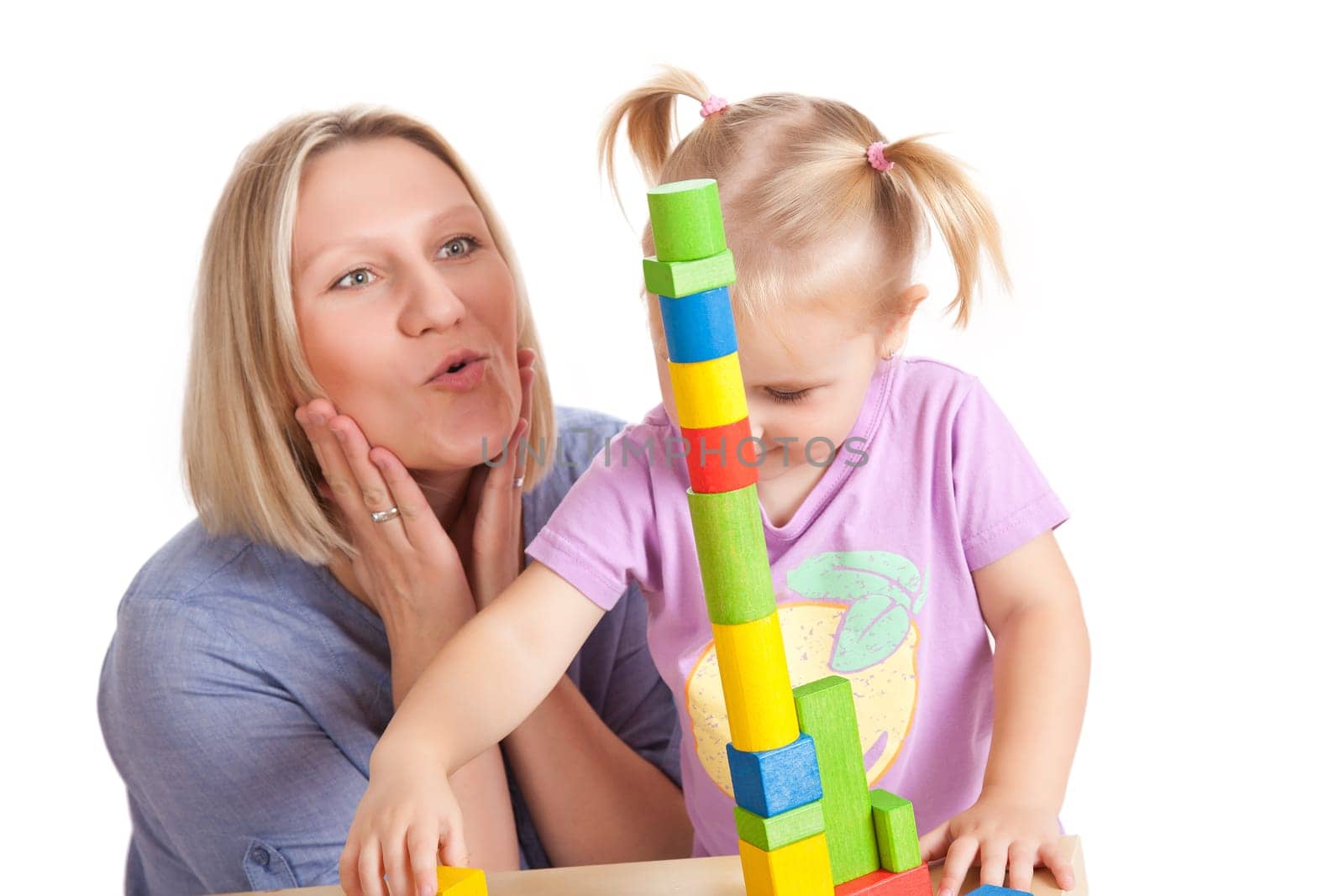 little girl and her mother playing with toy blocks