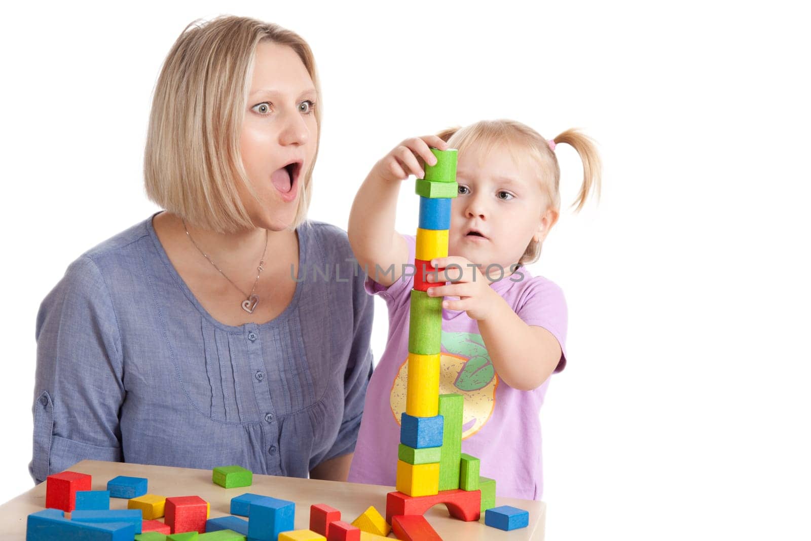 little girl and her mother playing with toy blocks