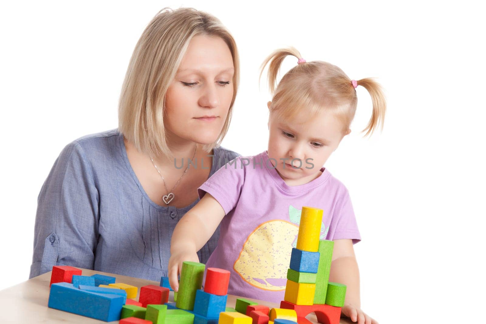 little girl and her mother playing with toy blocks