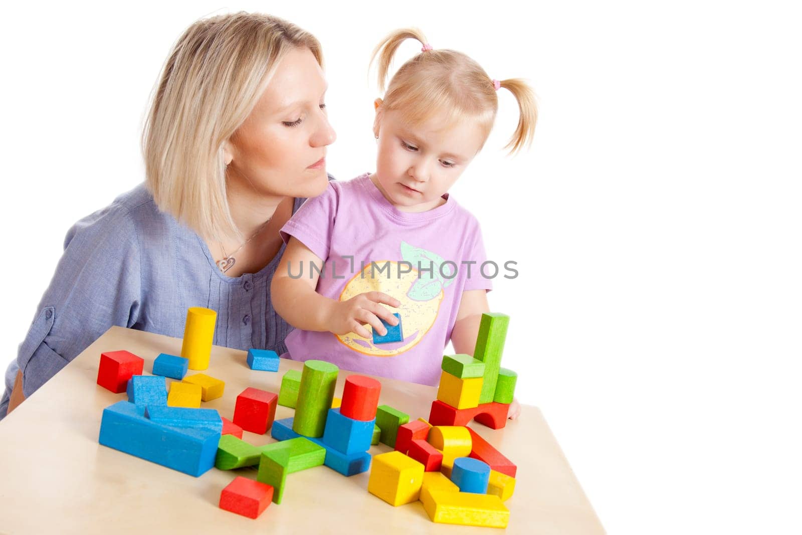 little girl and her mother playing with toy blocks
