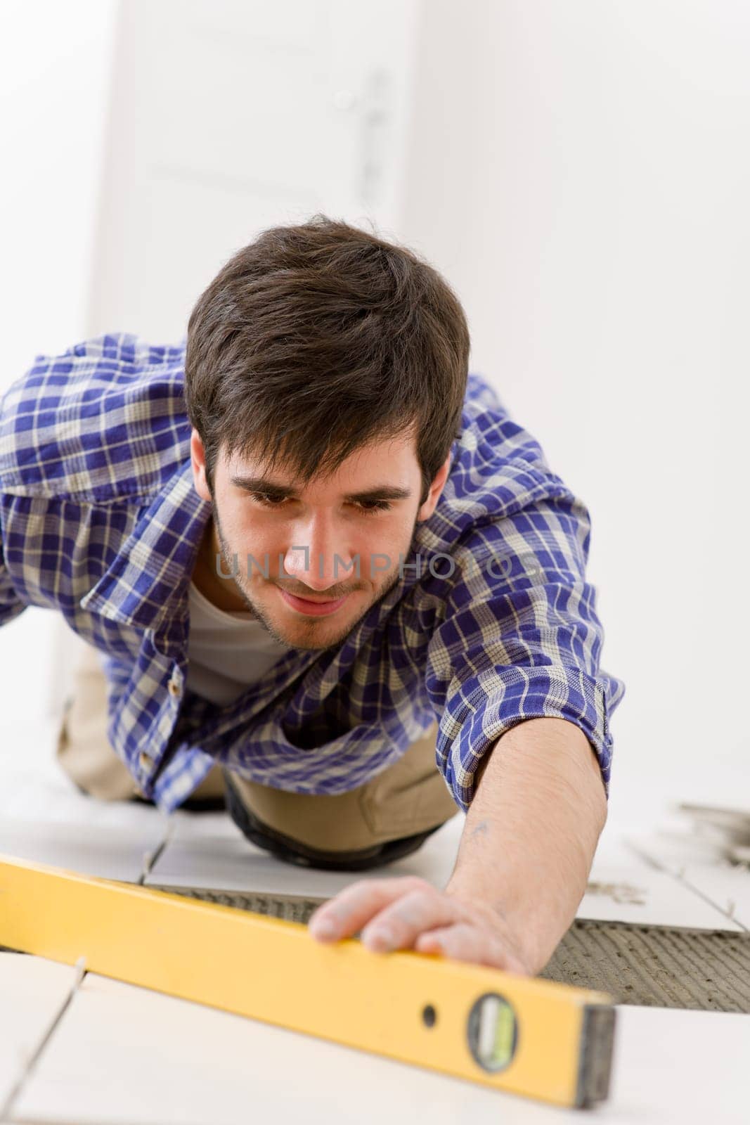 Home tile improvement - handyman with level