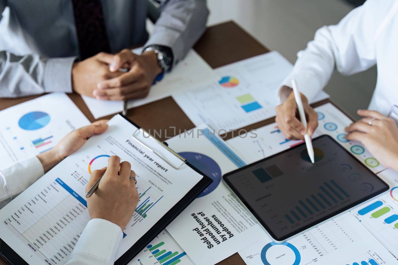 Business people teamwork with analysis cost graph on desk at meeting room.