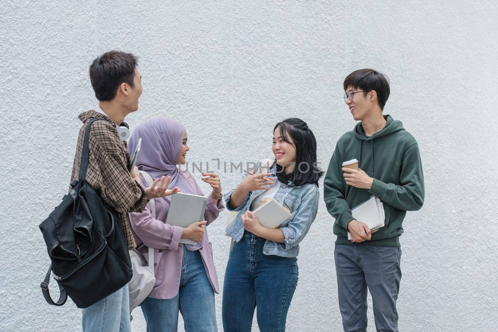 Outdoor of smiling university young group students college man and women students college smiling stand holding books and laptop computers on campus, Education concept, Back to college concept by wichayada