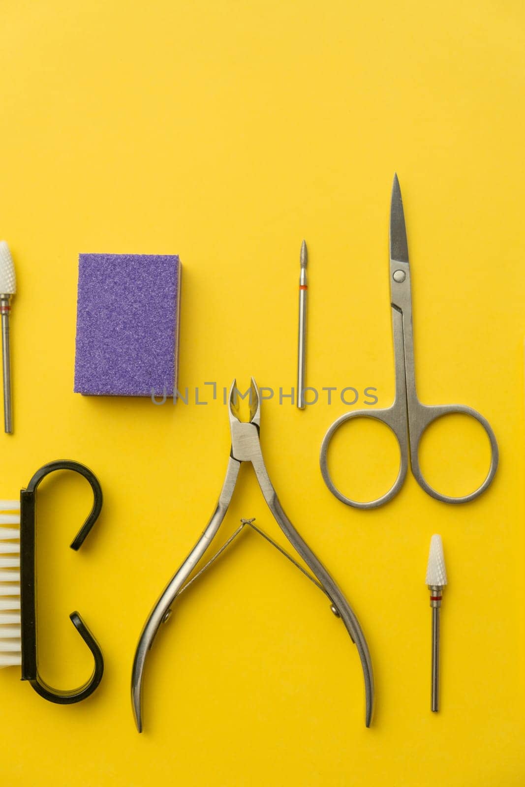 Professional manicure tools on yellow background. Manicure set. by AnatoliiFoto