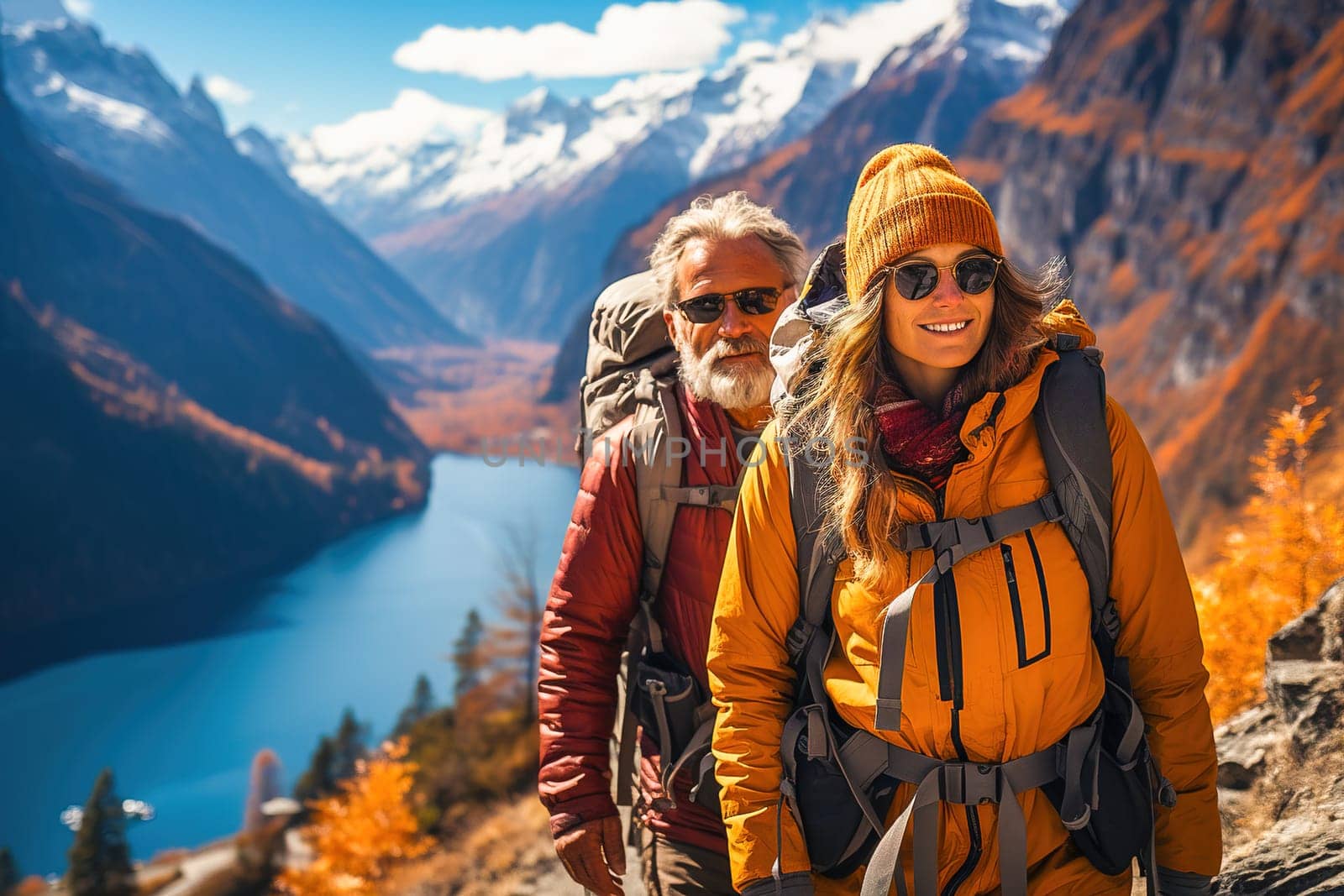 Portrait of a happy retired couple traveling in the mountains in autumn. High quality photo