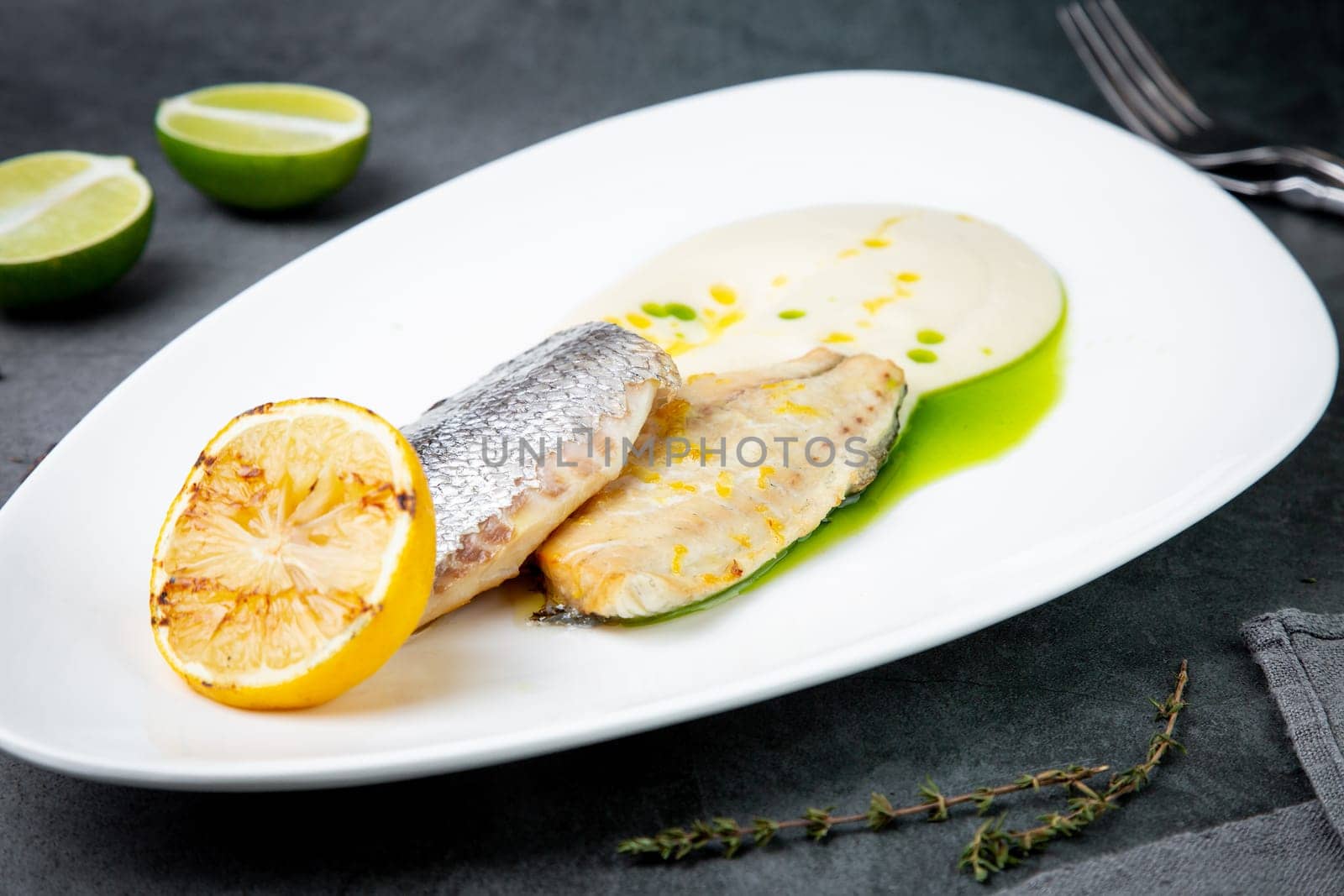 pieces of fried fish with sauce and fried lemon