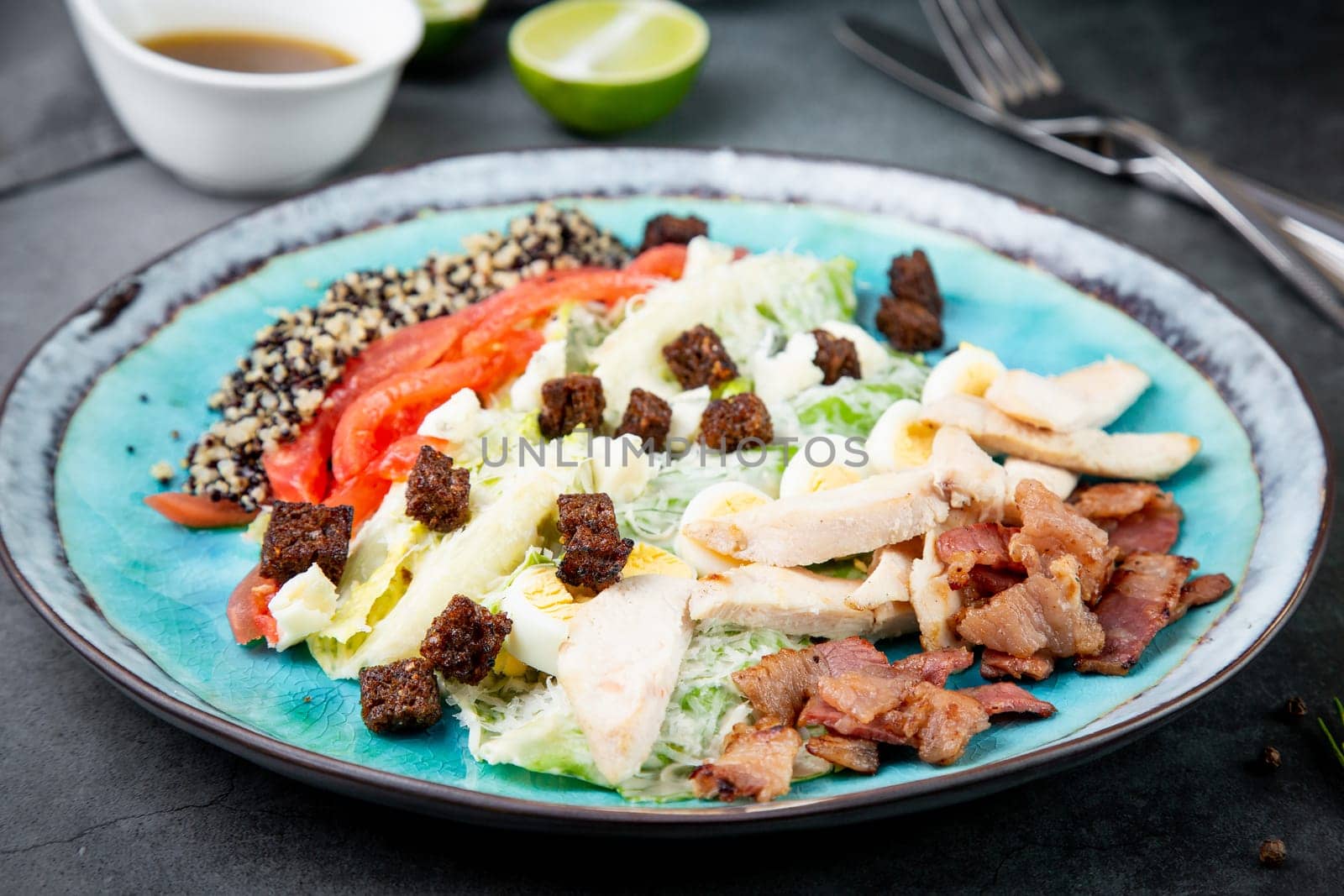 appetizer of meat, quail eggs, bell pepper, croutons, lettuce and sauce