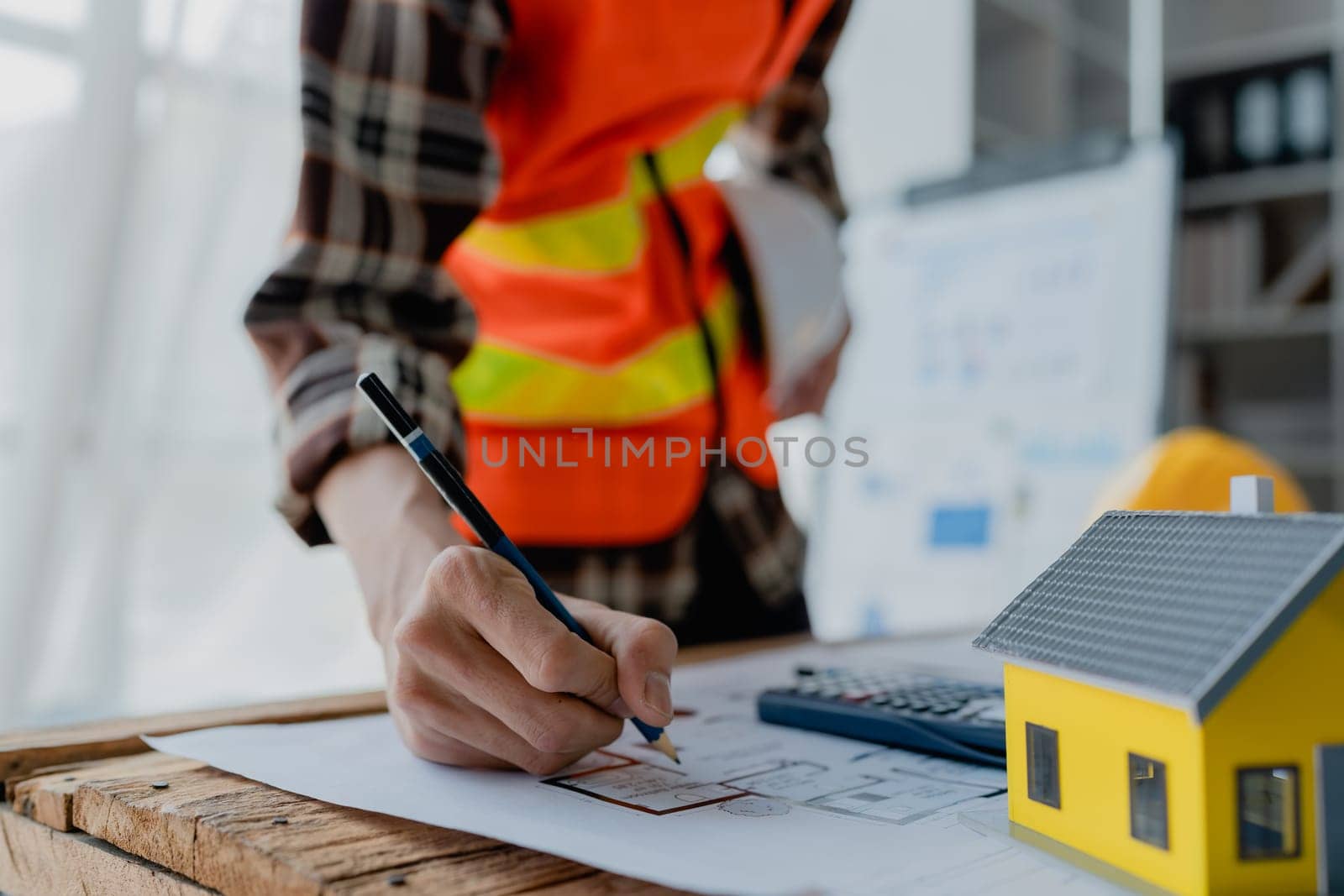 engineer brainstorming and measuring for cost estimating on blueprint and floor plan drawings about design architectural and engineering for houses and buildings by Manastrong