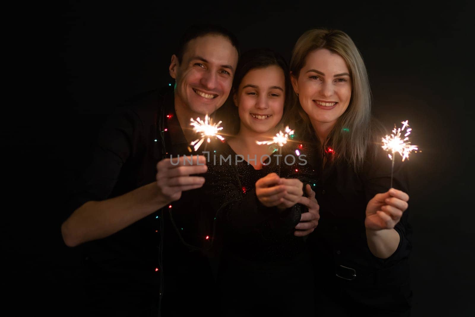 Merry Christmas and Happy Holiday. Family having fun on New Year. family with sparklers family with sparklers by Andelov13