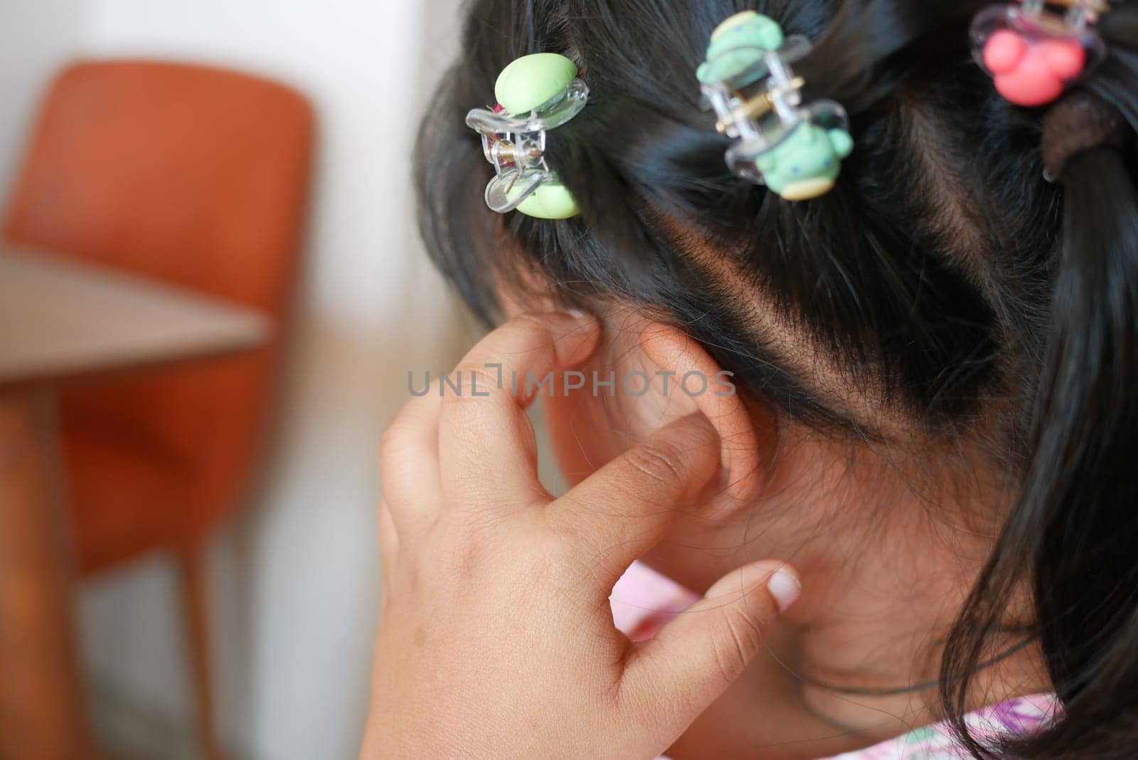 child girl having ear pain touching his painful ear , by towfiq007