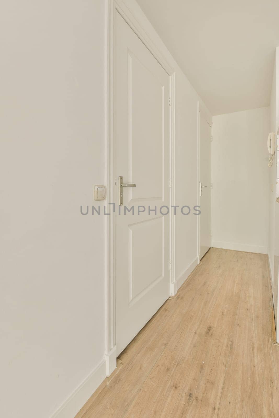 an empty room with white walls and a wooden floor by casamedia