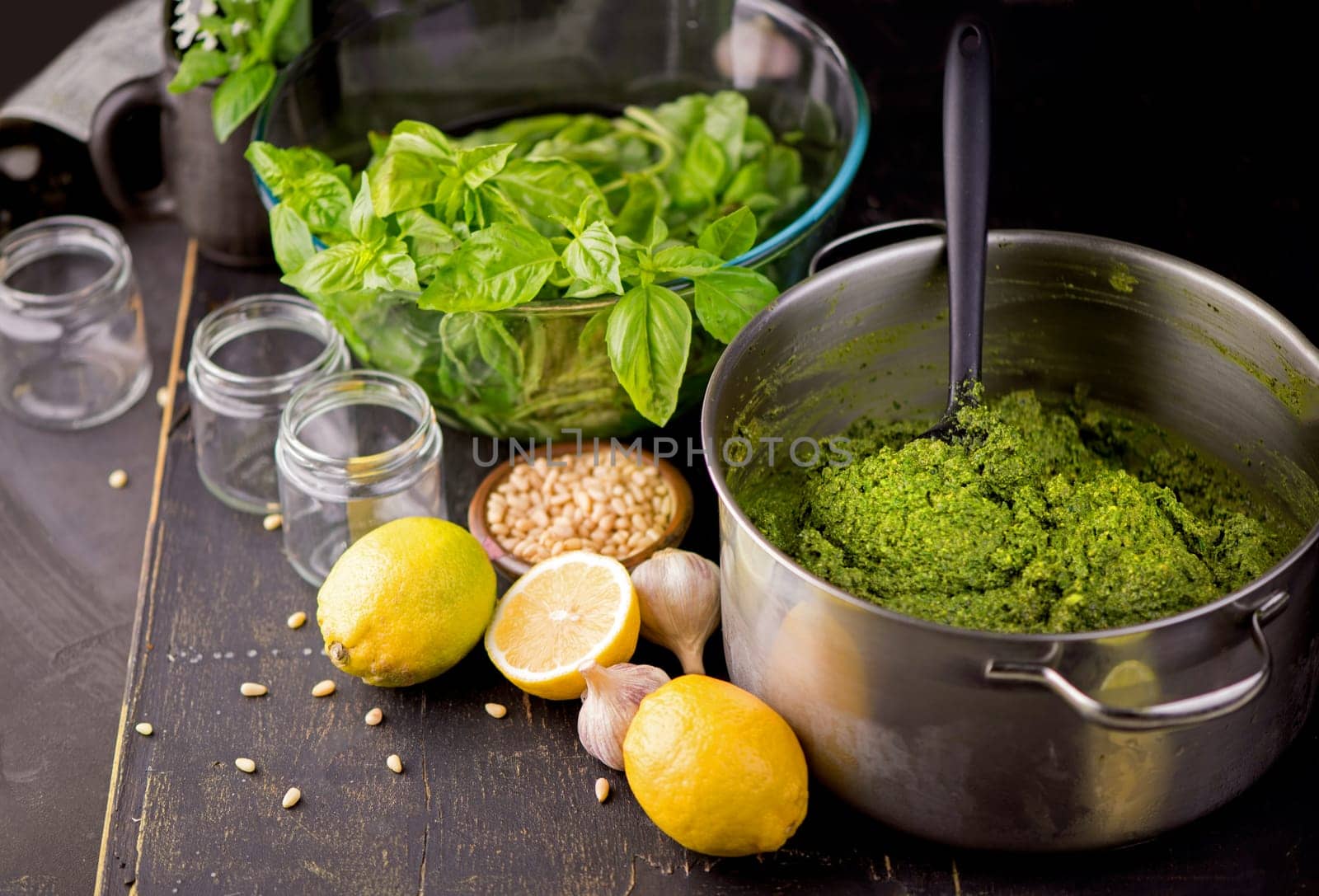 Fresh homemade pesto sauce close up and food ingredients for making pesto. Shallow depth of the field, toned and processing photo.
