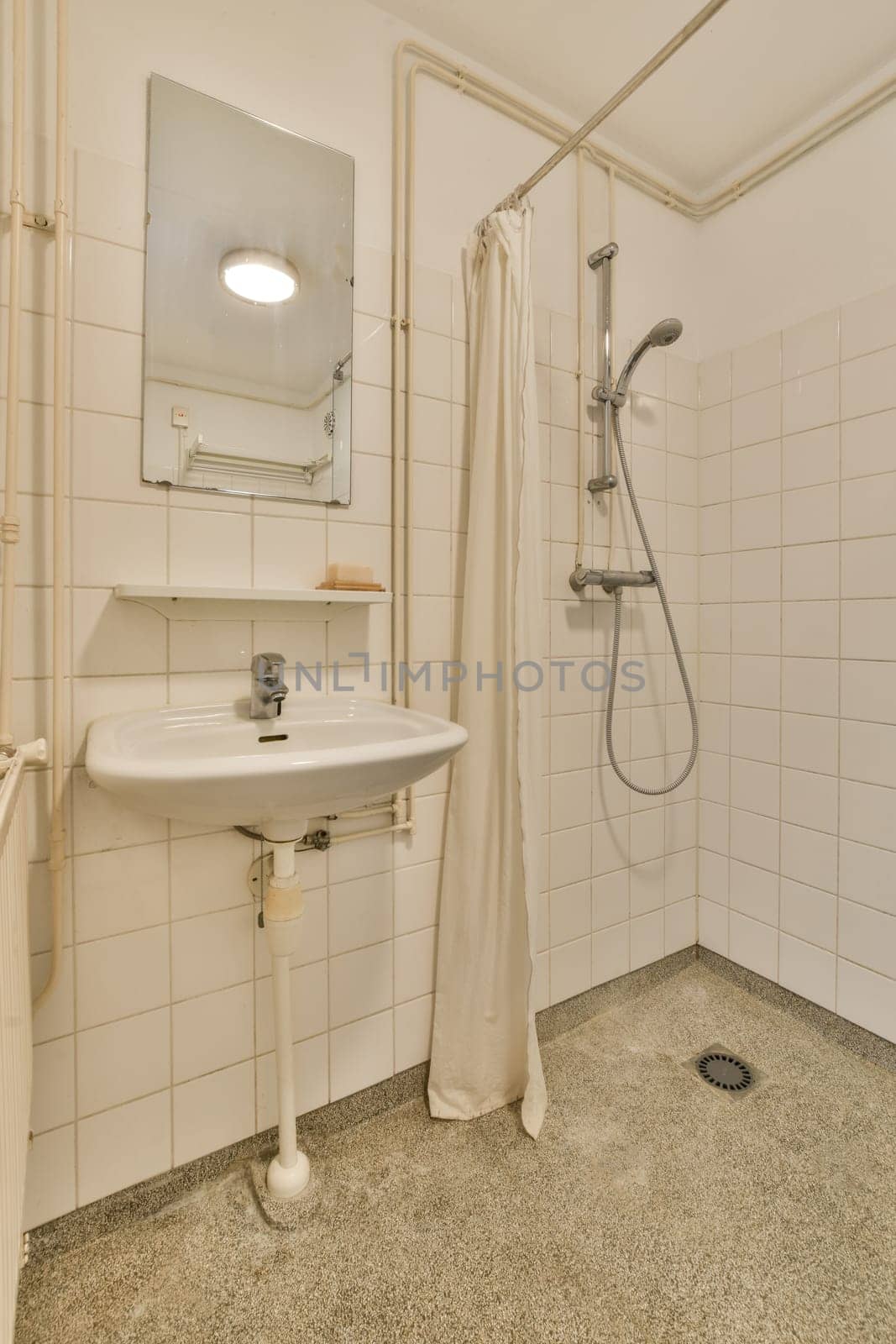 a small bathroom with a sink and a shower by casamedia