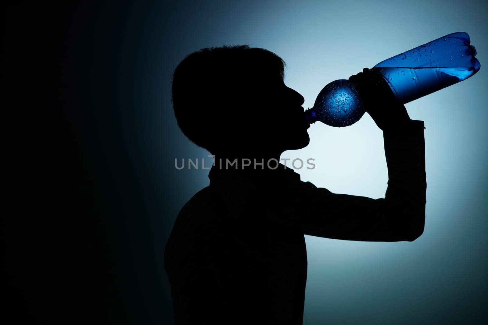 businesswoman drinking water in office
