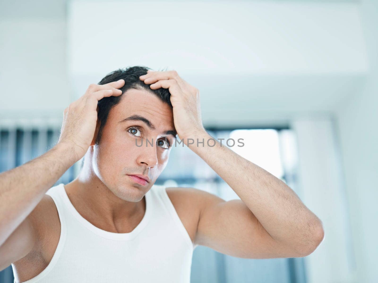 man checking receding hairline