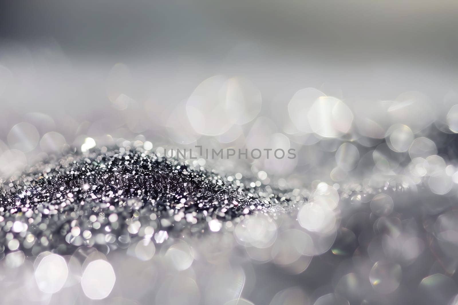 Shimmering silver glitter with soft bokeh effect in a dreamlike scene.