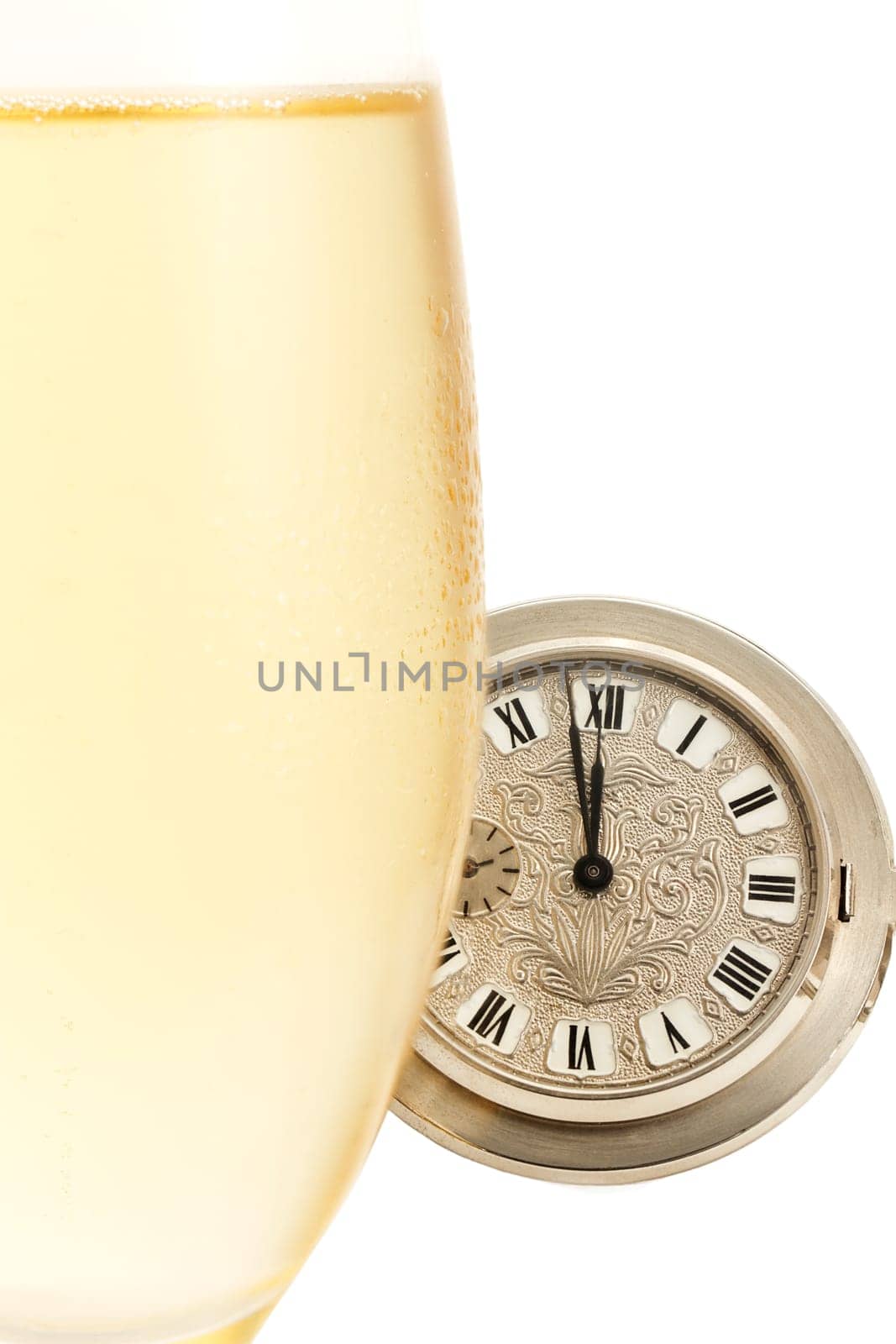 Cold glass of sparkling wine in front of pocket watch