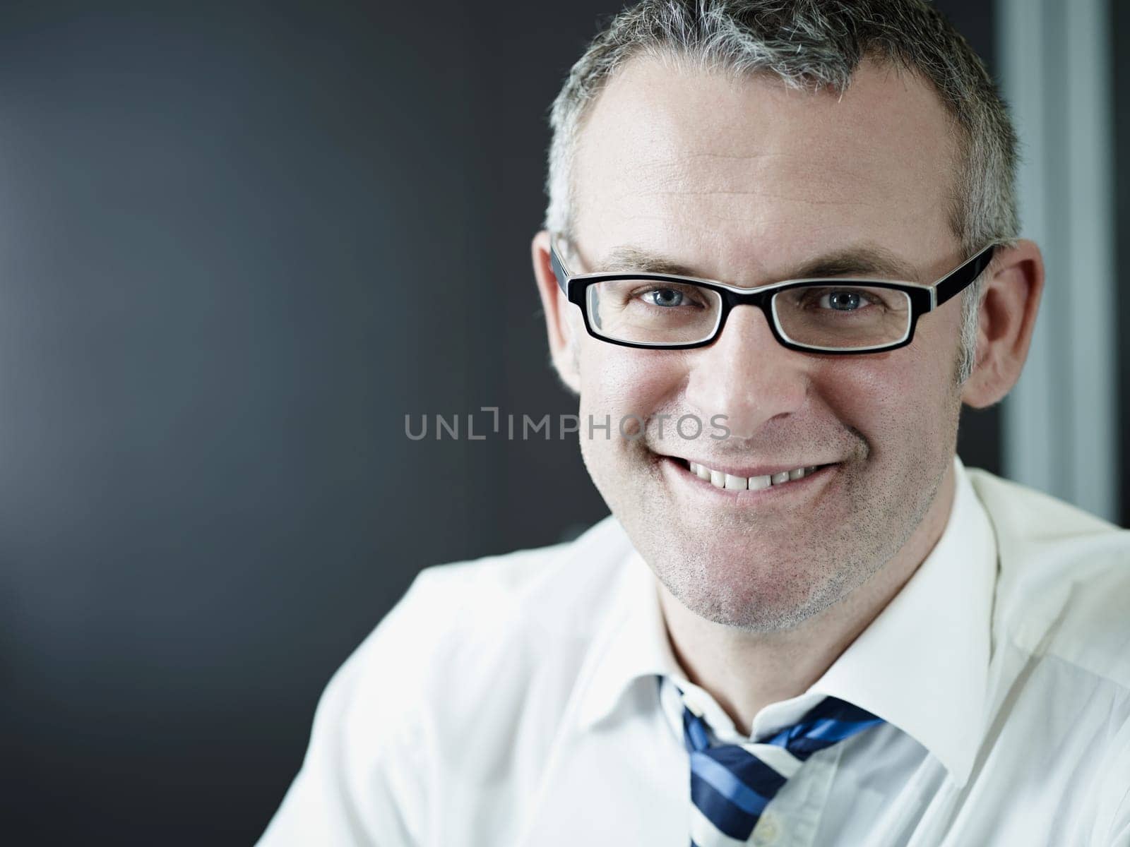 confident businessman smiling at camera