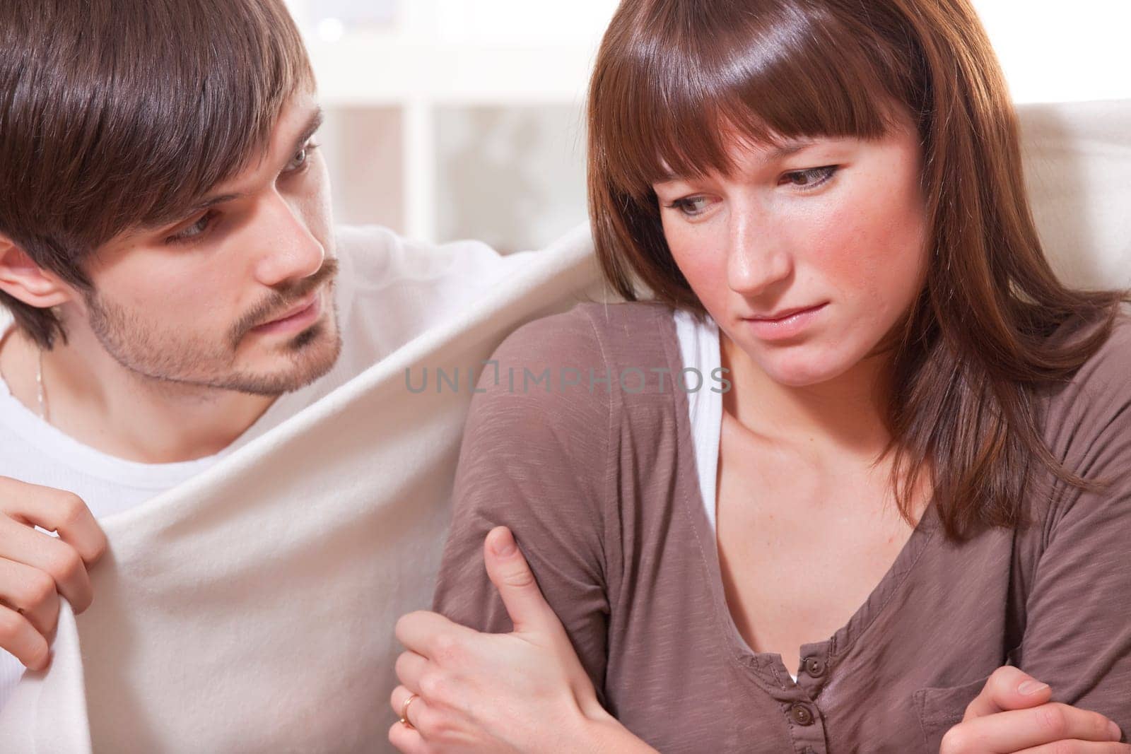 man and ill woman at home