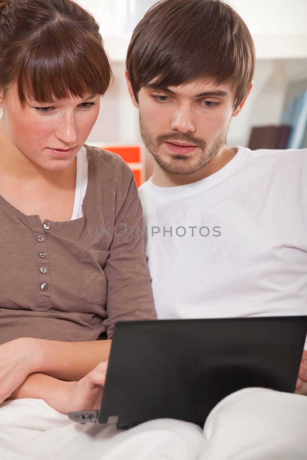 couple with laptop at home