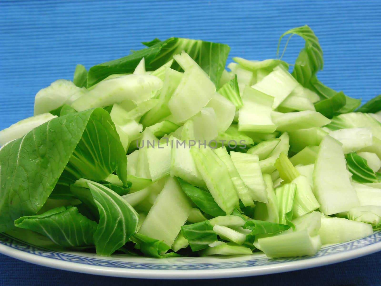 Pak Soi cut against blue background