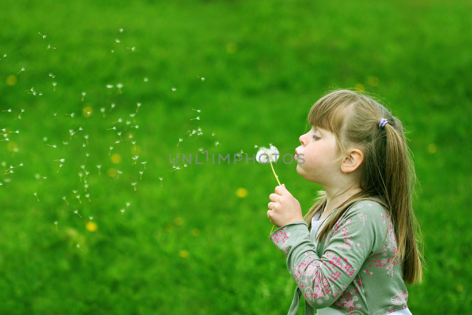 Girl playing with a flower
