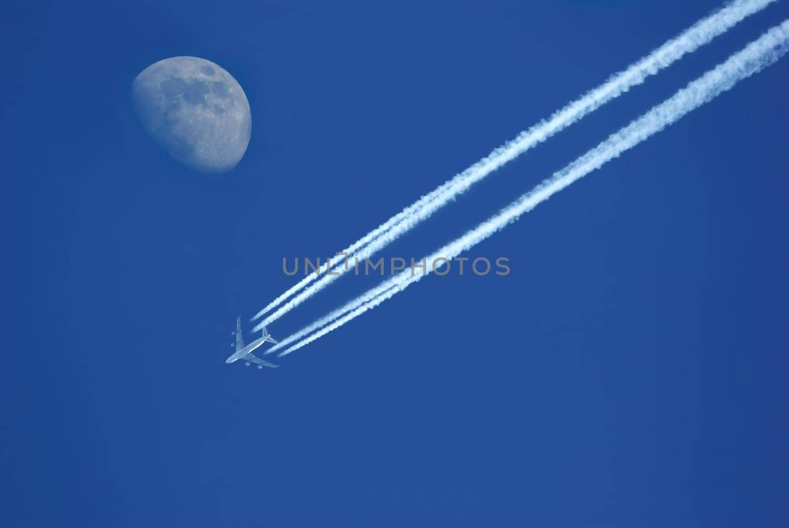 Airplane in the sky with moon