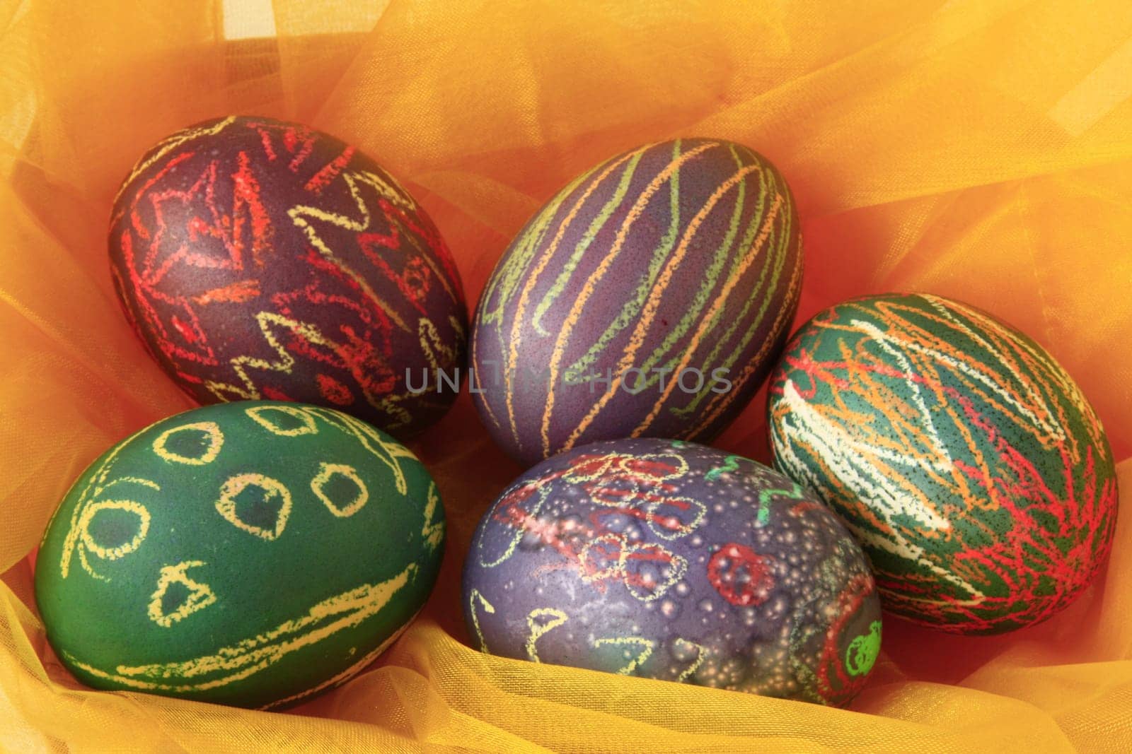 five brightly colored Easter eggs