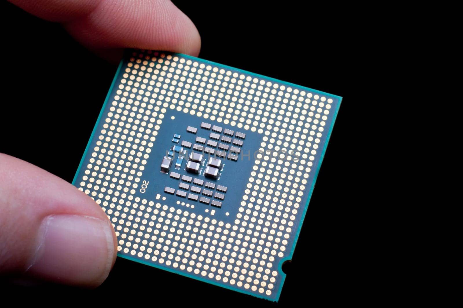 Computer processor held on black background