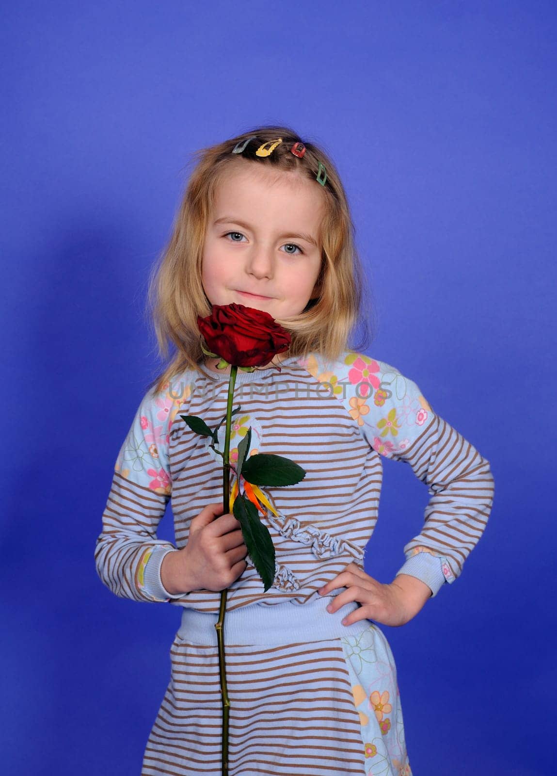 Little girl with red rose