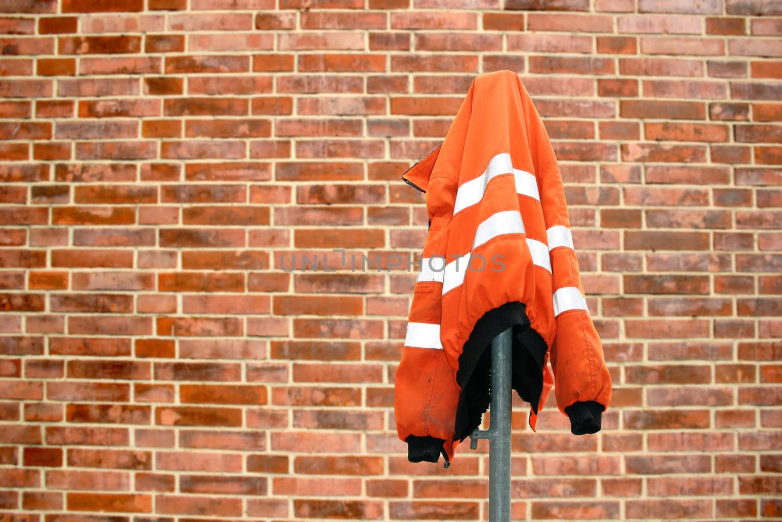 Construction site work jacket from brick wall