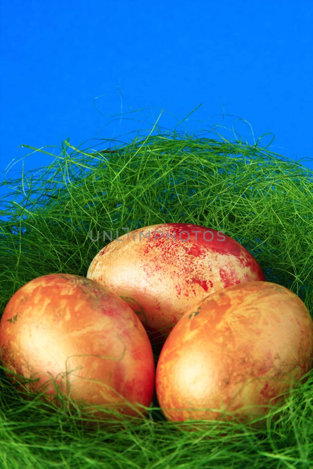 three golden yellow Easter eggs