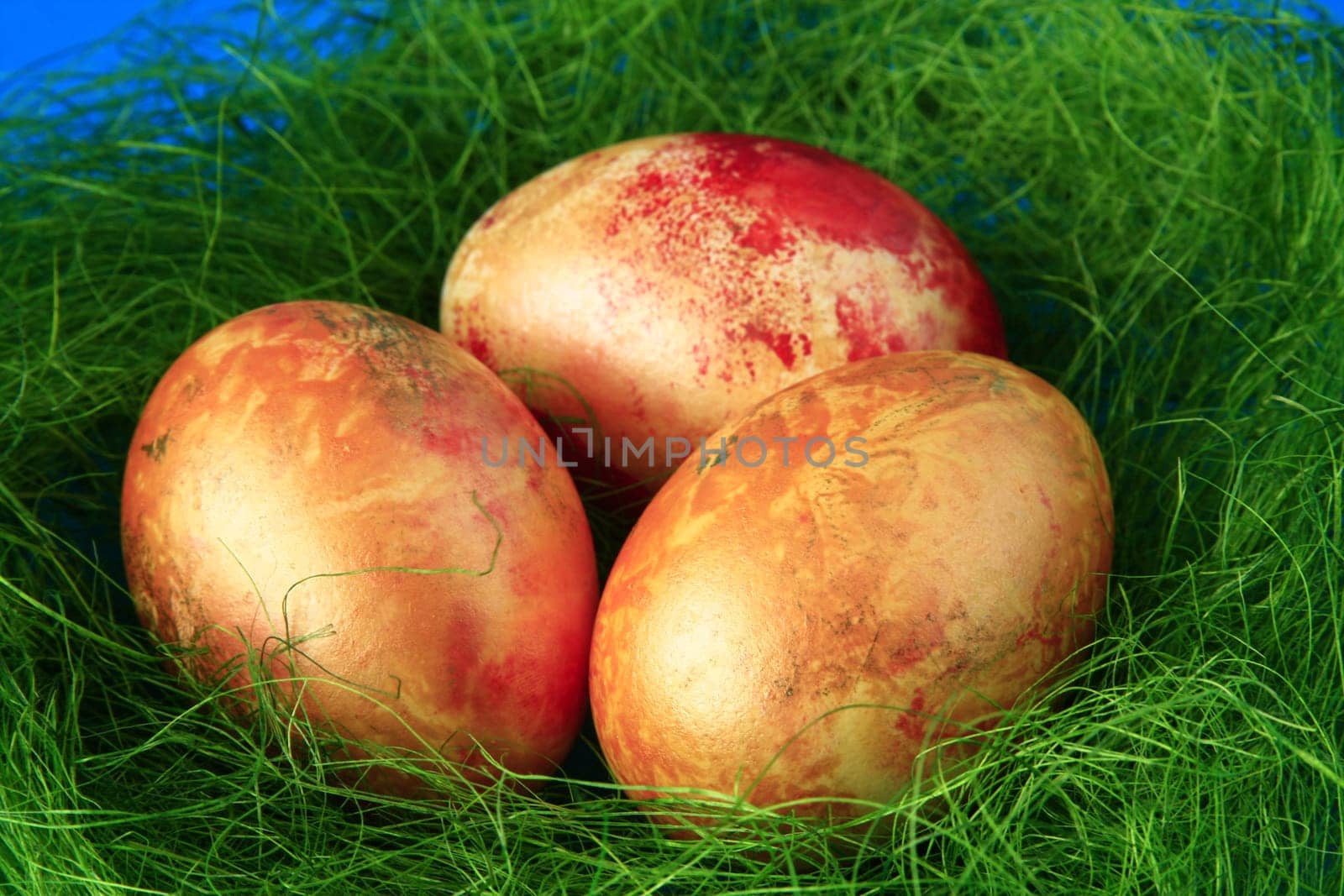 three golden yellow Easter eggs