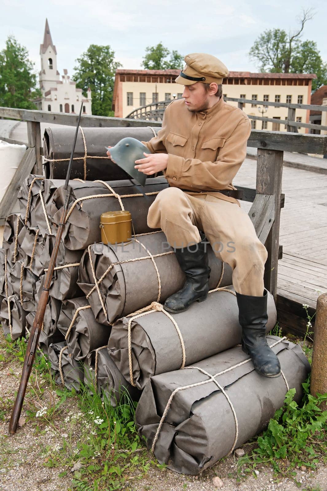 Soldier with helmet and gun sitting on t
