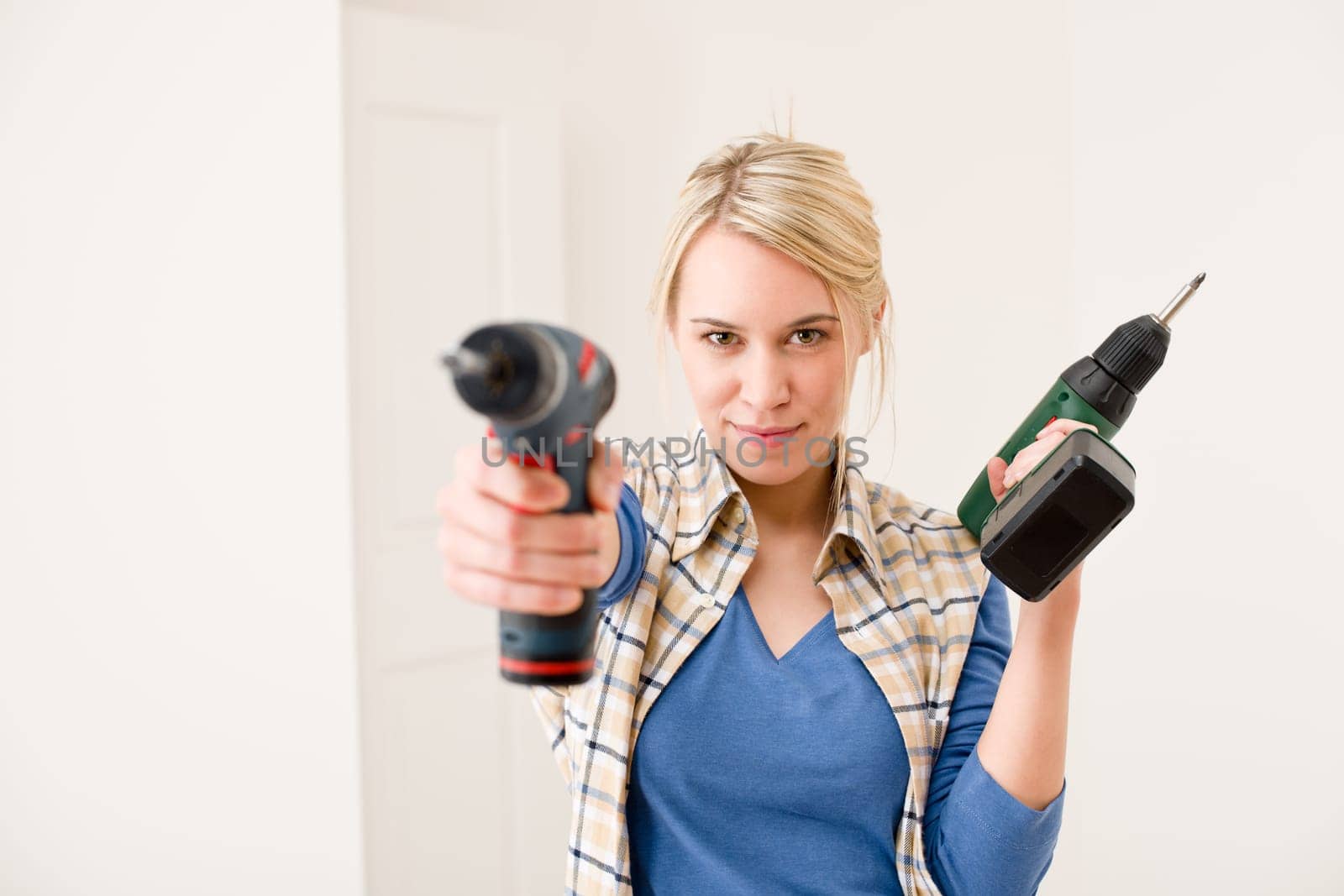Home improvement - woman with battery screwdriver
