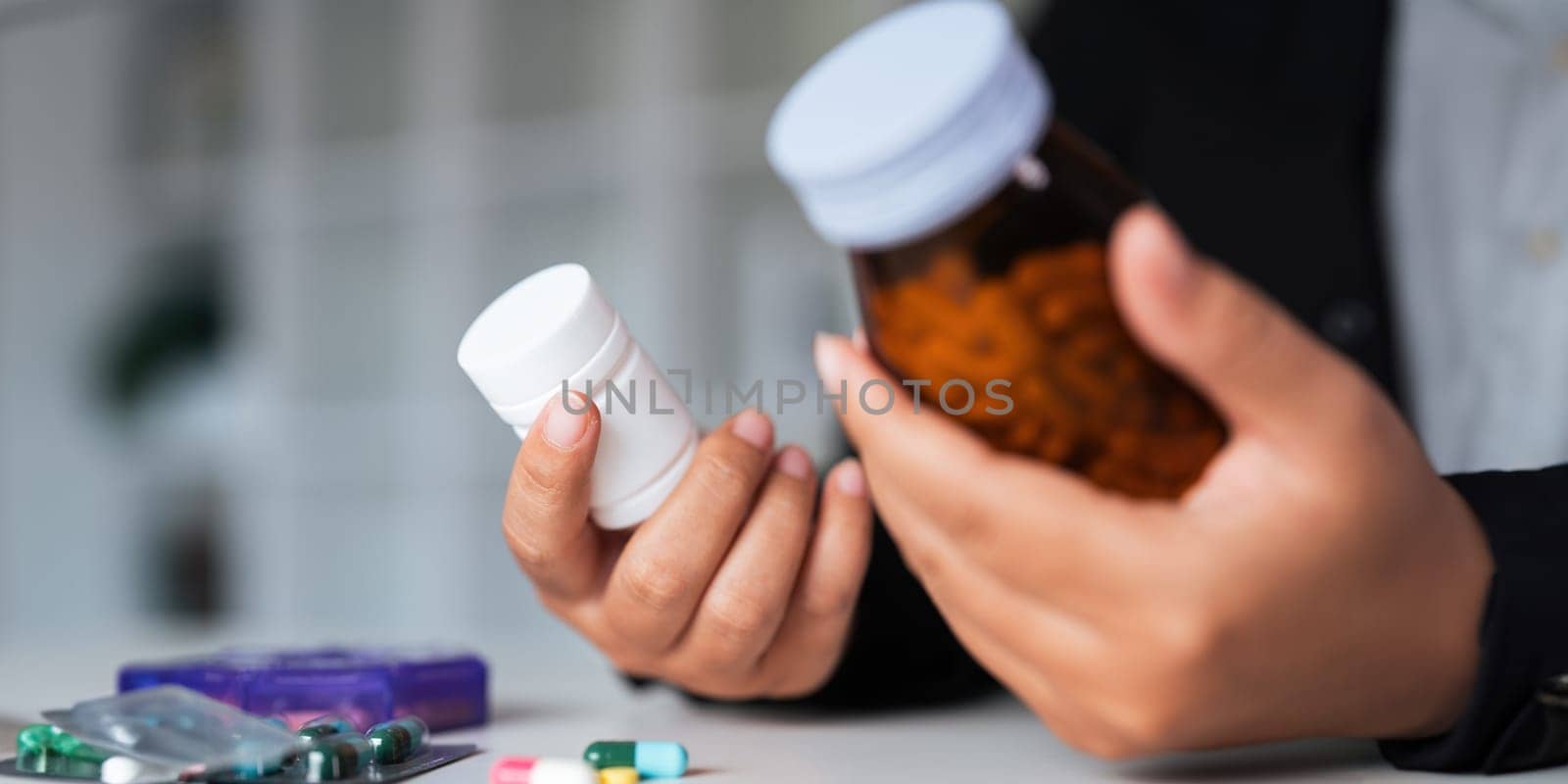 Woman hold bottle of drug tablet painkiller or vitamin supplement reading label ready to organizing medicine at home. medication healthcare concept.