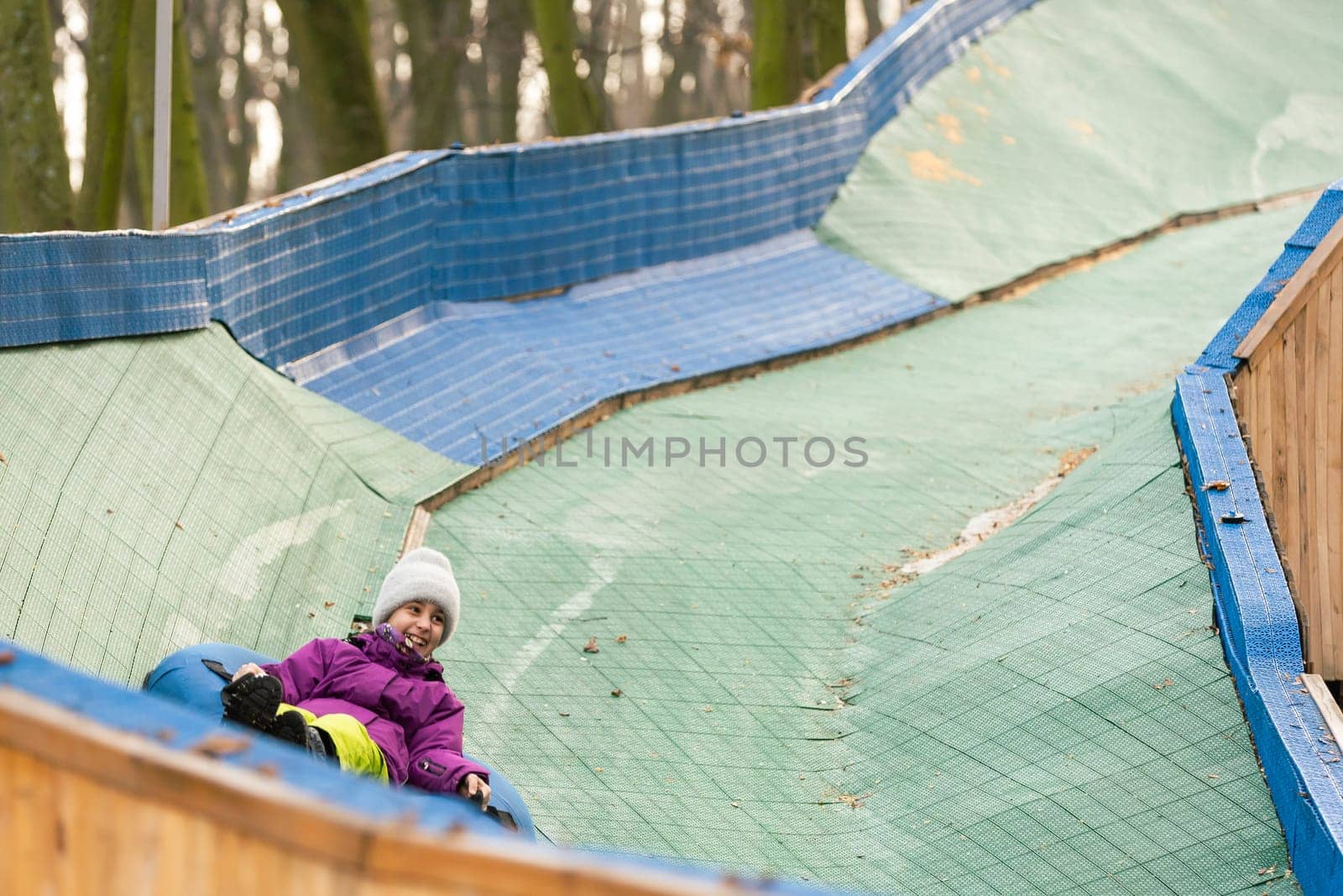 Children ride on tubing. Winter entertainment. Tubing. People roll on the slides. by Andelov13