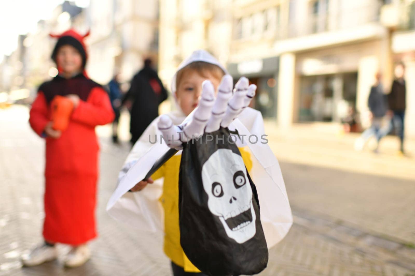 Children dressed up in the city on Halloween asking for candy
