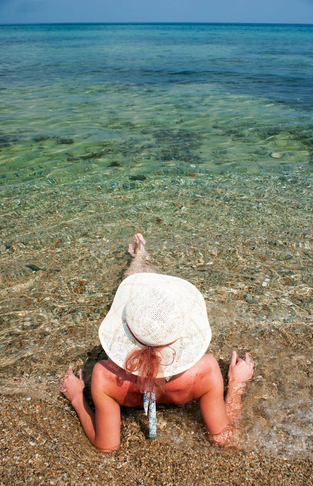 Woman with hat sunbathing