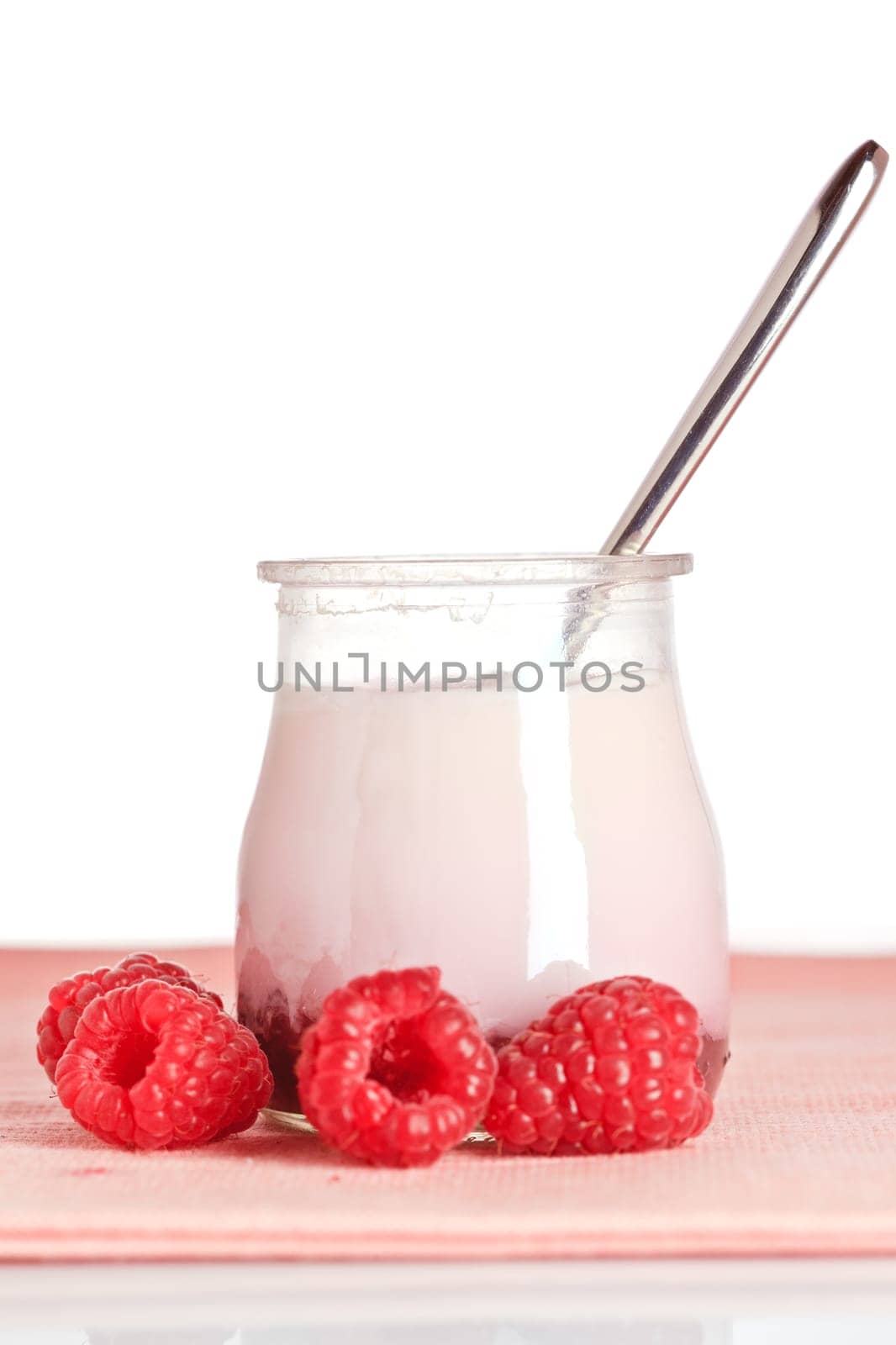 Raspberries yogurt with a spoon