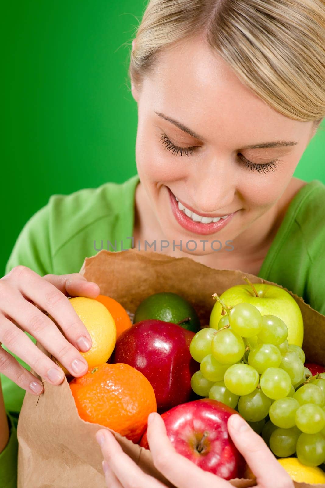 Healthy lifestyle - woman with fruit shopping paper bag