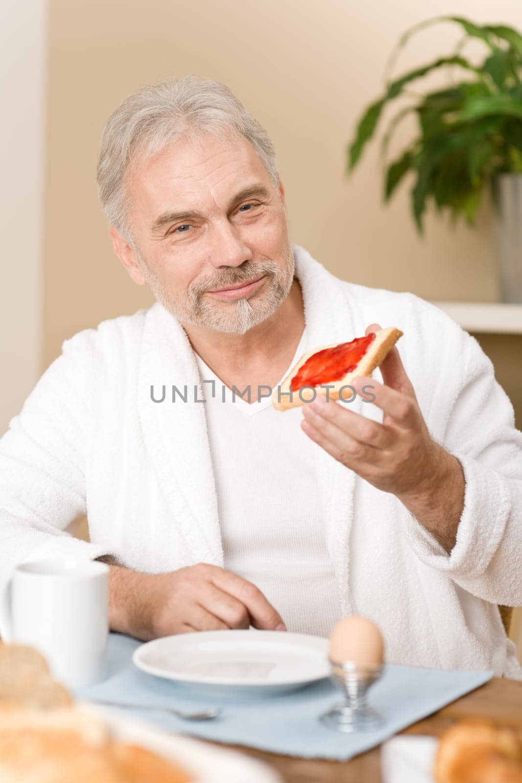 Senior mature man - breakfast at home