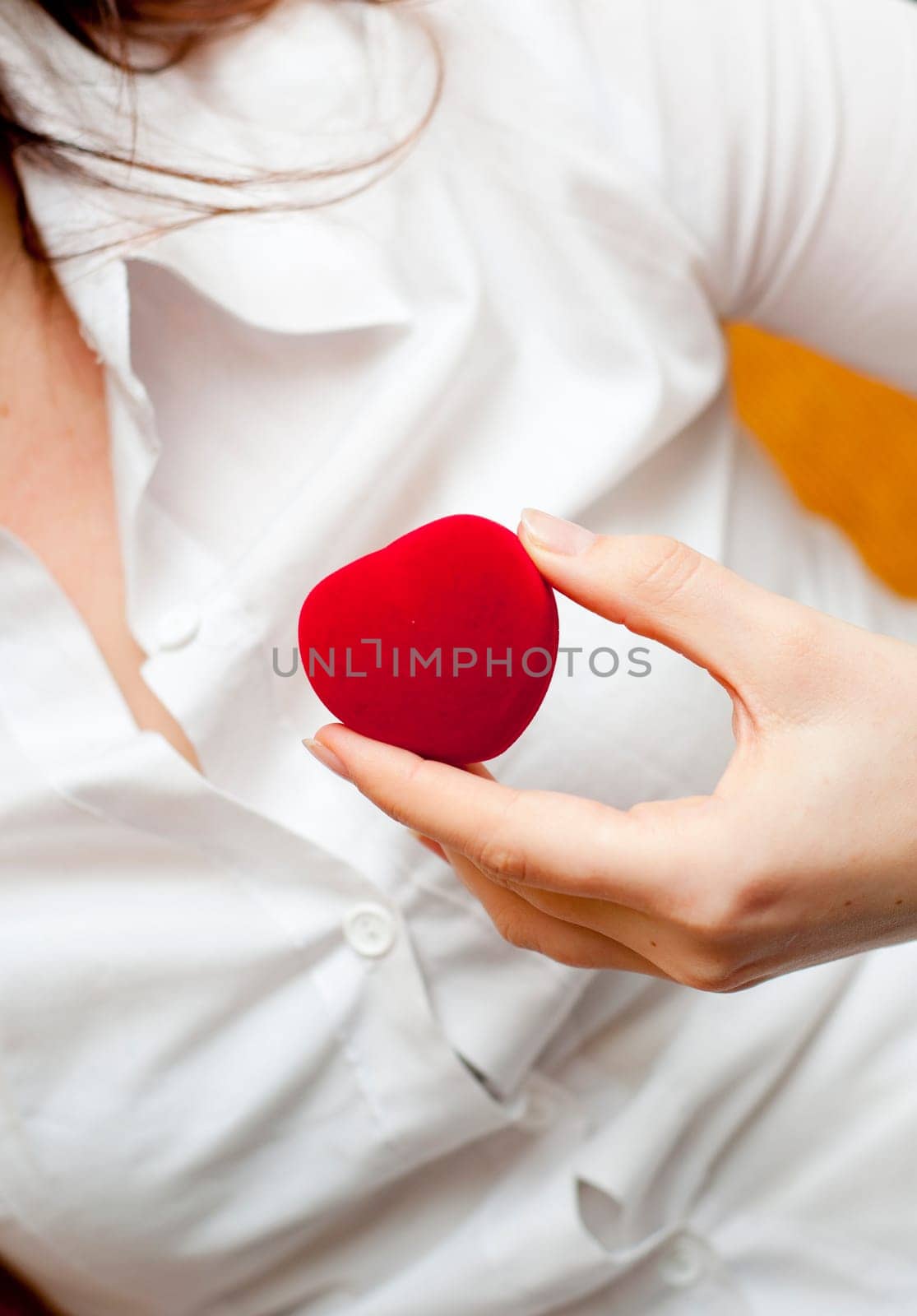 red engagement box holding by hand