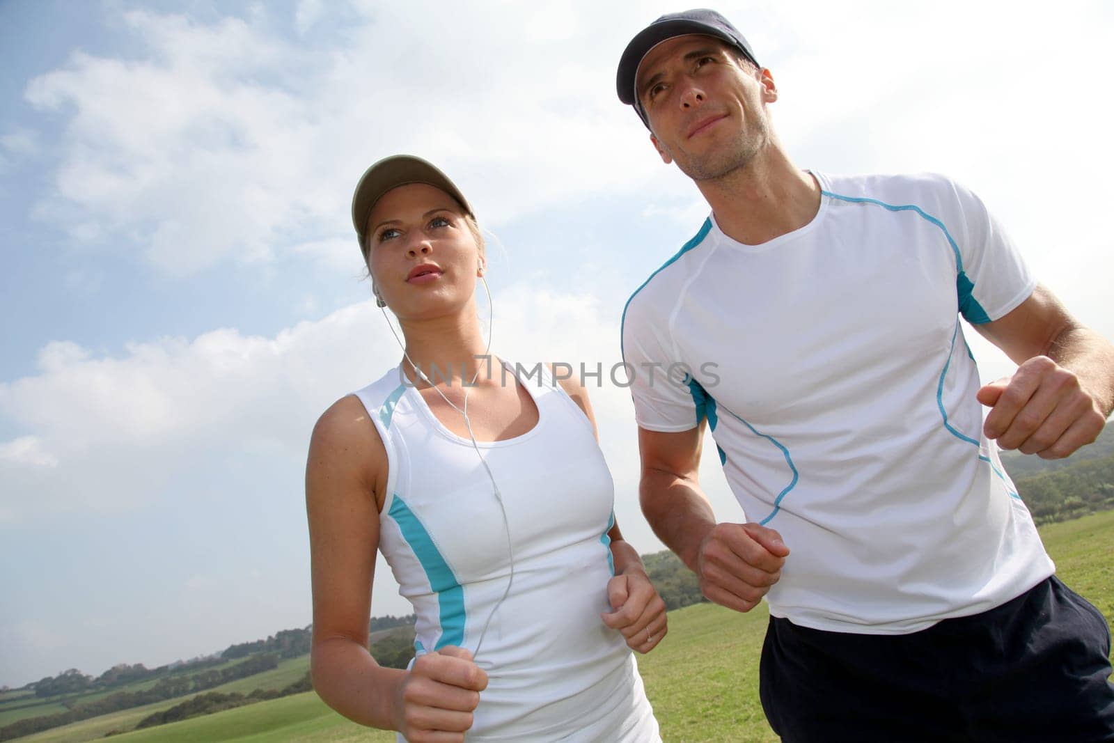 Couple running outside on a sunny day