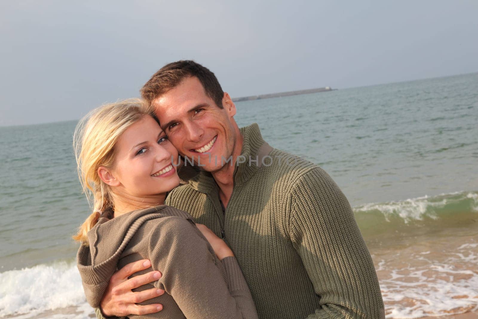 Lovers at the beach in autumn