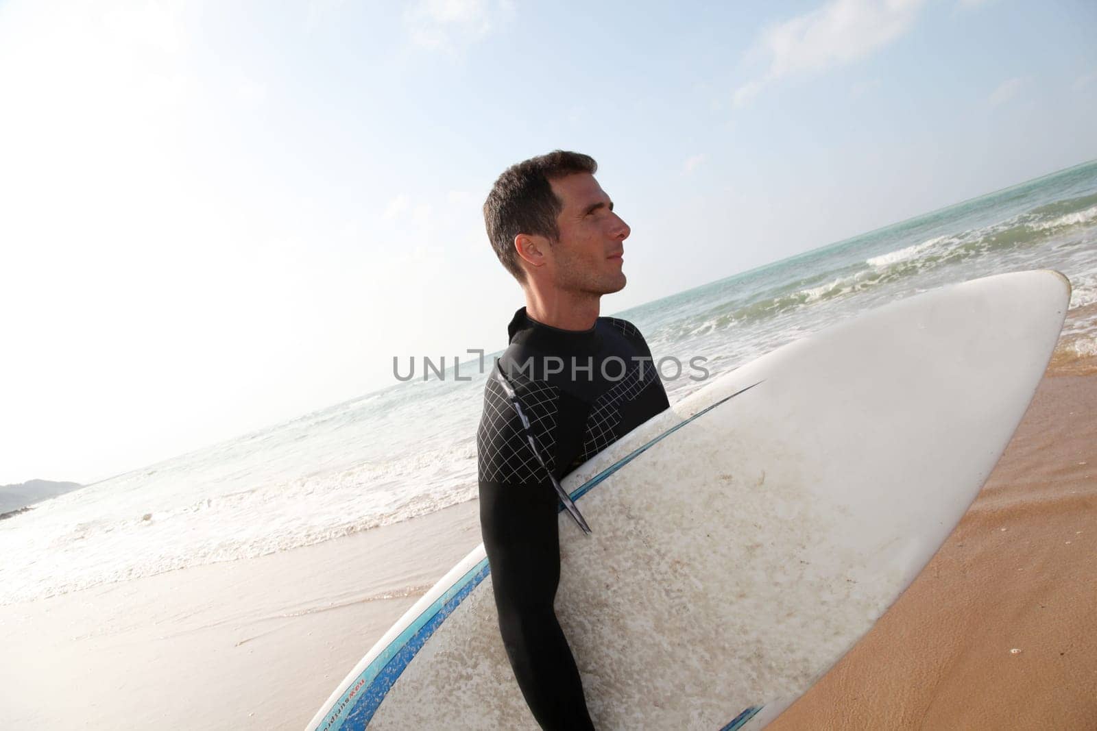 Man holding surfboard at the beach