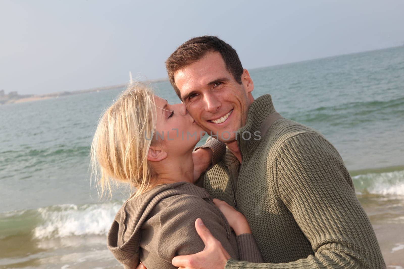 Lovers at the beach in autumn