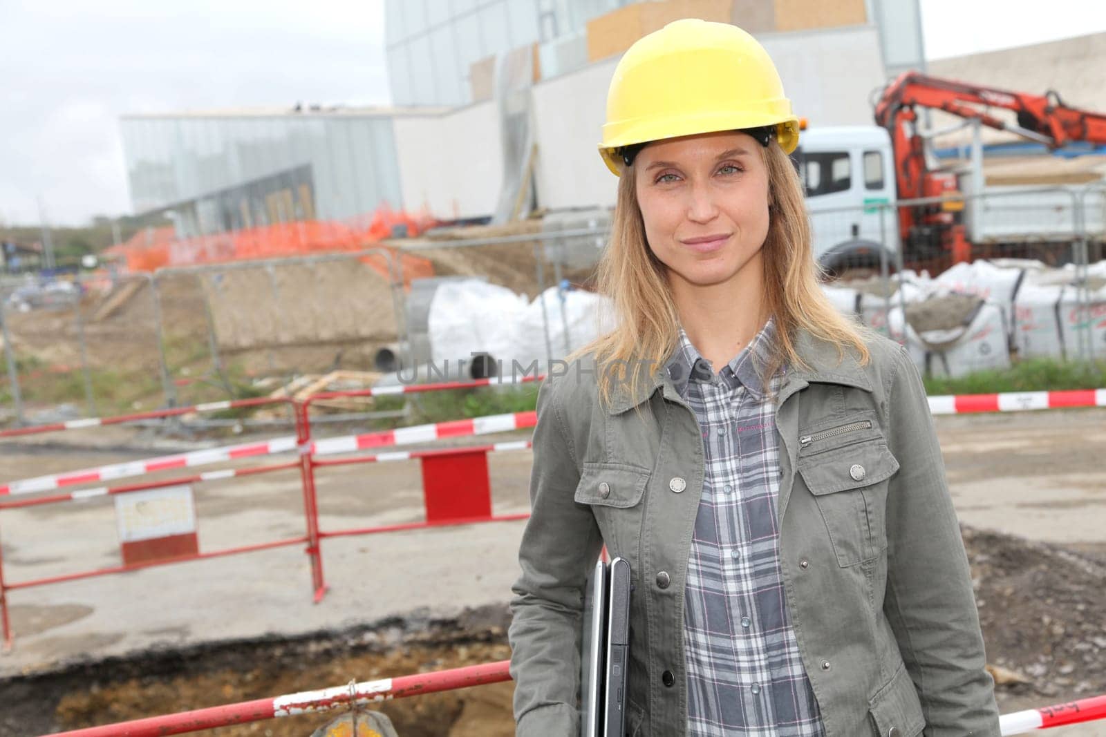 Architect on construction site with security helmet